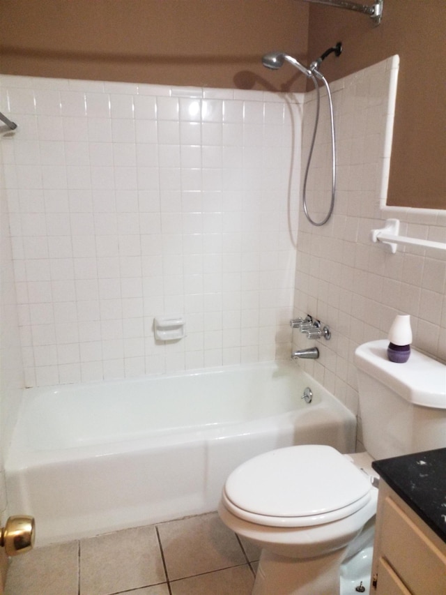 full bath with tile walls, shower / bathtub combination, toilet, vanity, and tile patterned floors