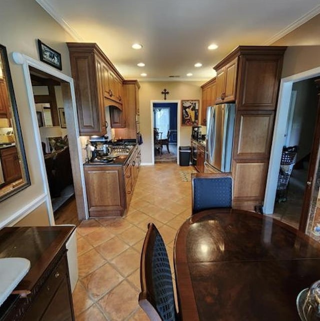 kitchen with ornamental molding, dark countertops, freestanding refrigerator, and recessed lighting