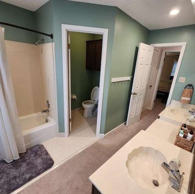 bathroom with baseboards, toilet, bathing tub / shower combination, and vanity