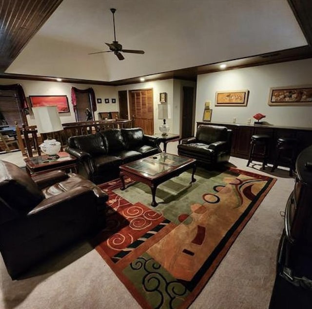 carpeted living area with lofted ceiling and a ceiling fan