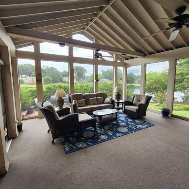 sunroom / solarium featuring lofted ceiling, plenty of natural light, and a ceiling fan