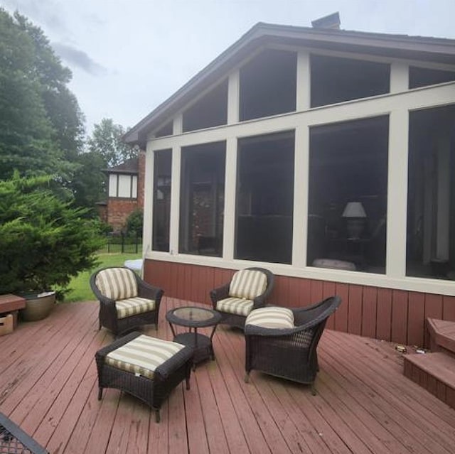 wooden deck featuring a sunroom