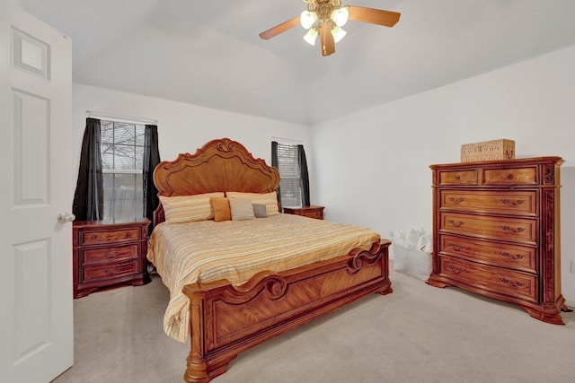 bedroom featuring light carpet, ceiling fan, and lofted ceiling