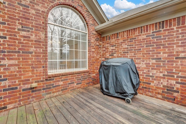 wooden deck with a grill