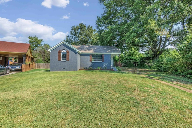 view of front facade with a front yard, crawl space, brick siding, and fence