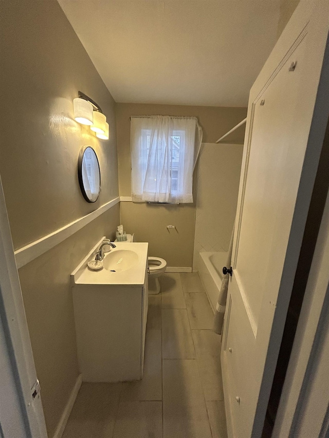 full bath featuring  shower combination, vanity, toilet, and baseboards