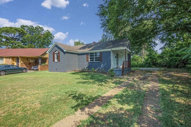 single story home featuring crawl space, a front yard, and brick siding