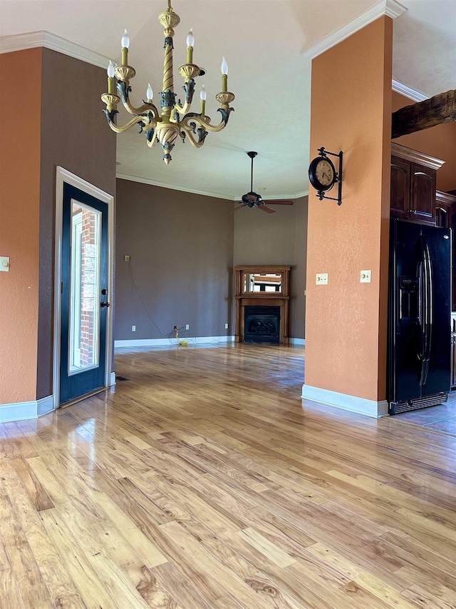 unfurnished living room with ornamental molding, a fireplace, light wood finished floors, and ceiling fan with notable chandelier