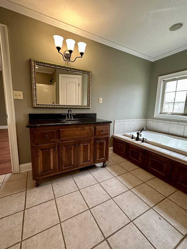 bathroom with ornamental molding, vanity, a bath, and tile patterned floors