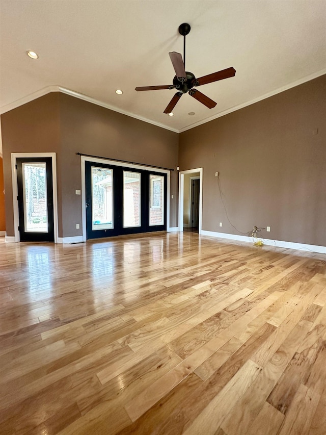 unfurnished living room with light wood finished floors, baseboards, and a ceiling fan