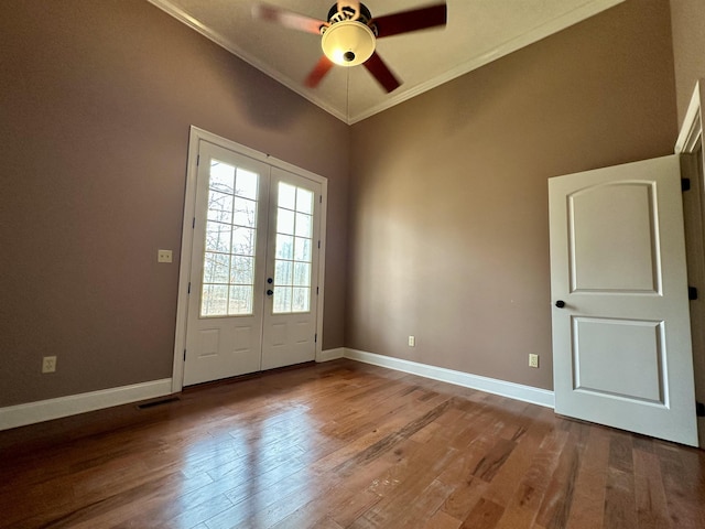 doorway to outside featuring baseboards, visible vents, ornamental molding, and wood finished floors