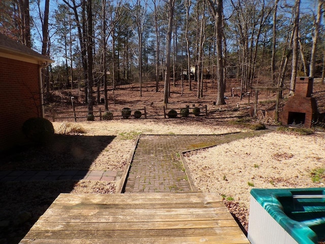 view of yard featuring exterior fireplace