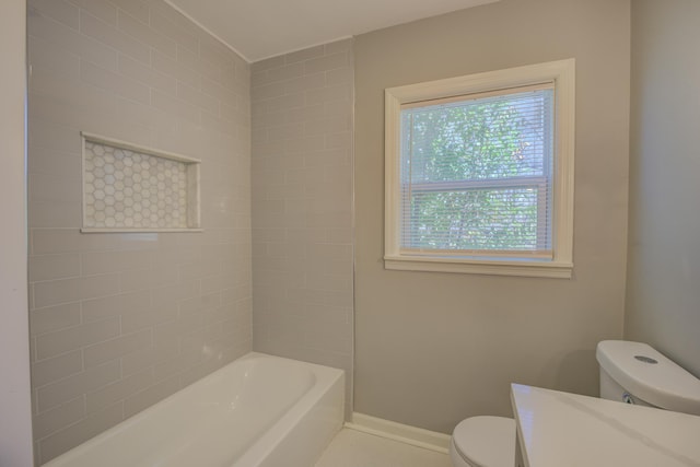 bathroom with shower / tub combination, toilet, and baseboards