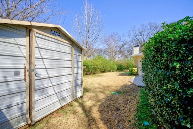view of yard with an outdoor structure and a storage unit
