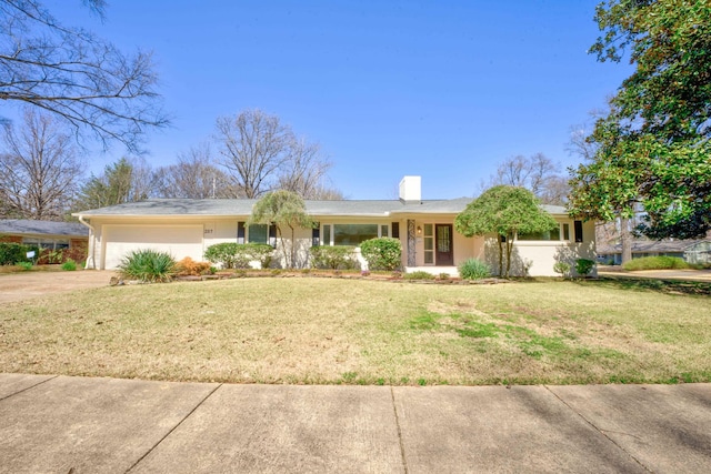 ranch-style house with a front lawn, concrete driveway, a garage, and a chimney