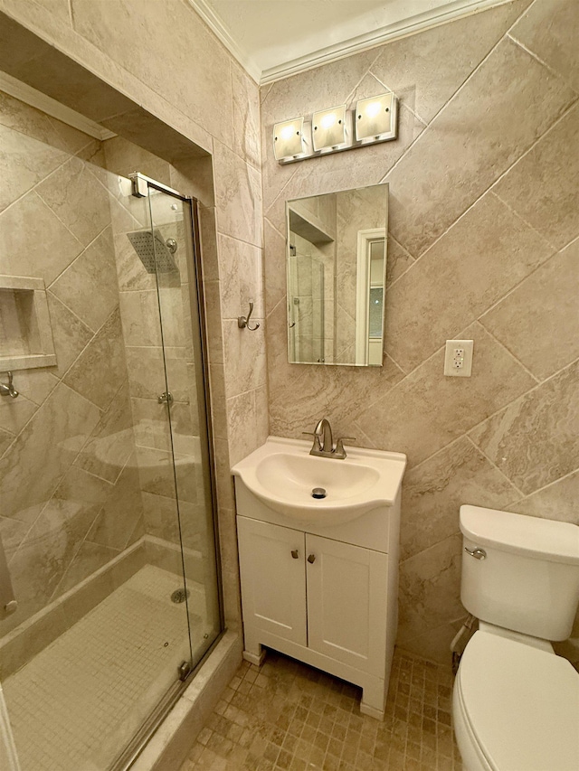 full bathroom with vanity, ornamental molding, a shower stall, and toilet