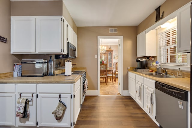 kitchen with stainless steel appliances, a sink, and white cabinets