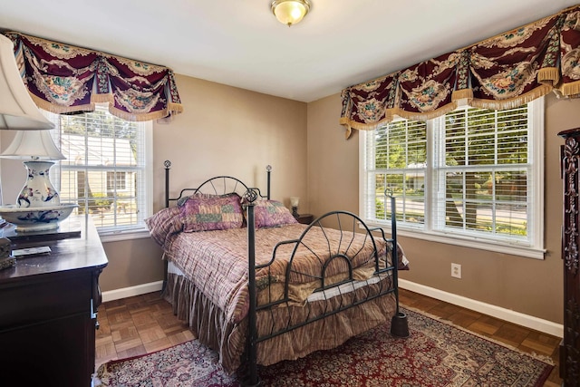 bedroom with multiple windows and baseboards