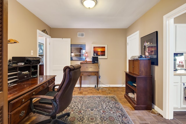 office space with baseboards and visible vents