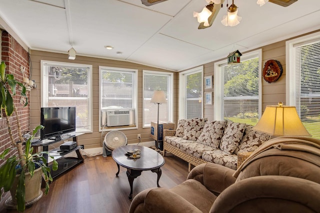 living room with cooling unit, vaulted ceiling, and wood finished floors