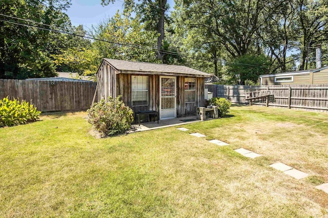 view of outdoor structure with a fenced backyard and an outdoor structure