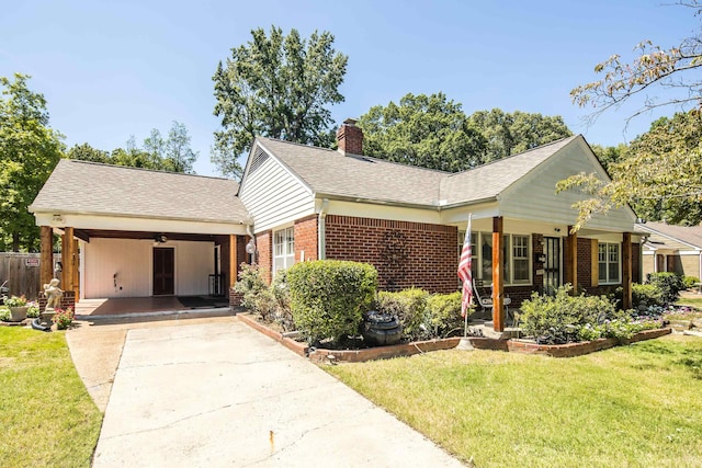 view of front of property featuring brick siding, a chimney, a shingled roof, driveway, and a front lawn