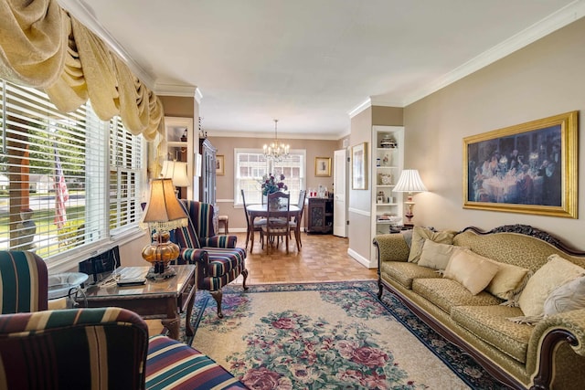 living room with a chandelier, ornamental molding, and baseboards