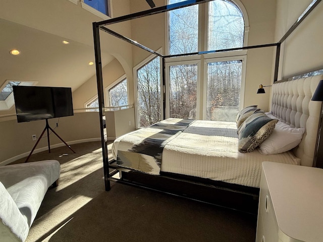 carpeted bedroom featuring recessed lighting, baseboards, and a high ceiling