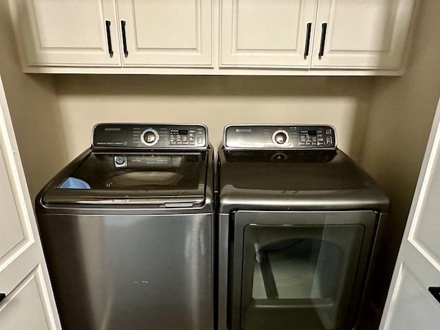 laundry area featuring cabinet space and washing machine and clothes dryer