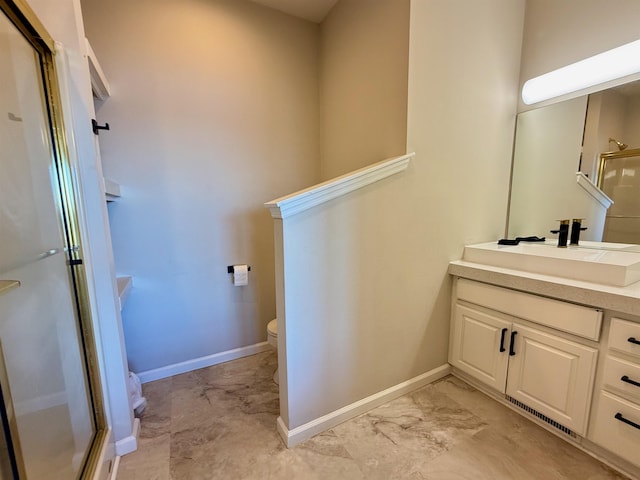 bathroom featuring toilet, a stall shower, vanity, and baseboards