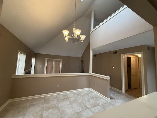 tiled spare room with lofted ceiling, an inviting chandelier, visible vents, and baseboards