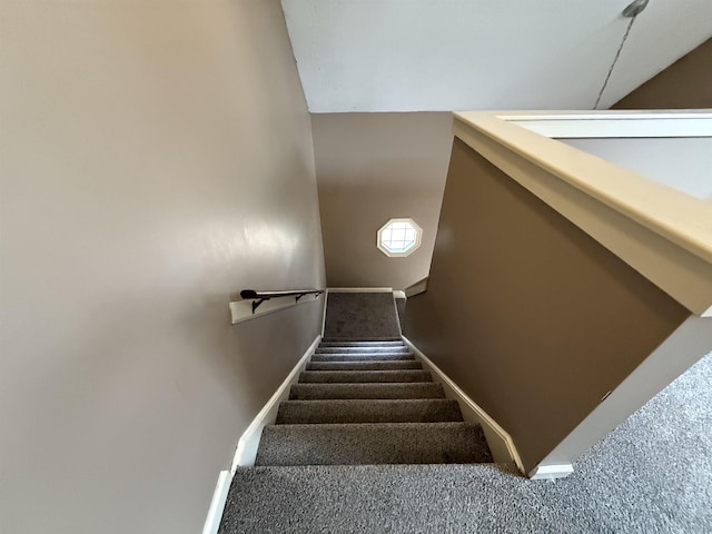 staircase with carpet floors and baseboards