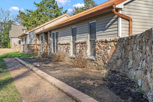 view of side of property featuring stone siding