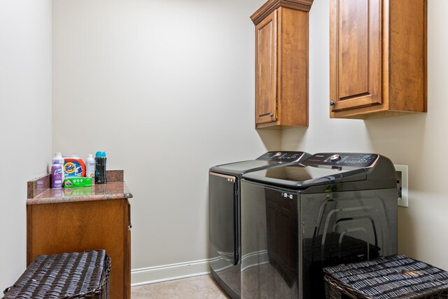 14029 Knightsbridge Ln, Olive Branch, MS 38654 - laundry area with baseboards, cabinet space, and washing machine and clothes dryer