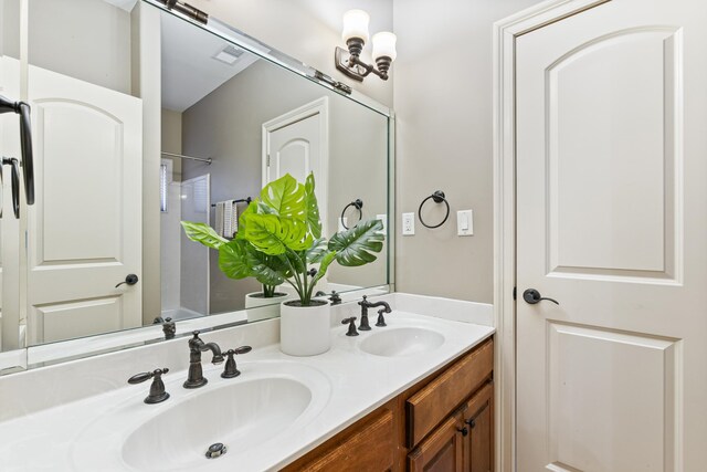 14029 Knightsbridge Ln, Olive Branch, MS 38654 - full bath with double vanity, walk in shower, a sink, and visible vents