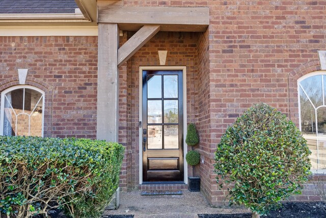 14029 Knightsbridge Ln, Olive Branch, MS 38654 - view of exterior entry with roof with shingles and brick siding