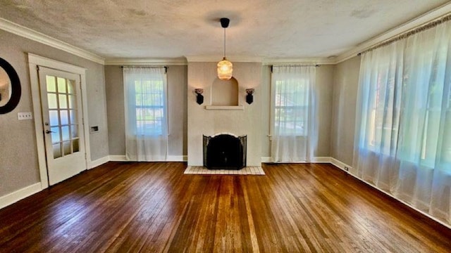 unfurnished living room with hardwood / wood-style floors, a fireplace, and crown molding