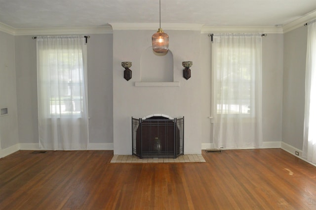 unfurnished living room with a fireplace with flush hearth, ornamental molding, and wood finished floors