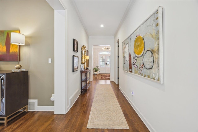 corridor featuring crown molding, recessed lighting, visible vents, wood finished floors, and baseboards