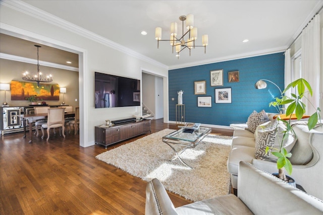 living area featuring an inviting chandelier, baseboards, ornamental molding, and wood finished floors