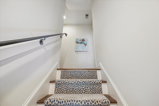 staircase featuring visible vents and wood finished floors