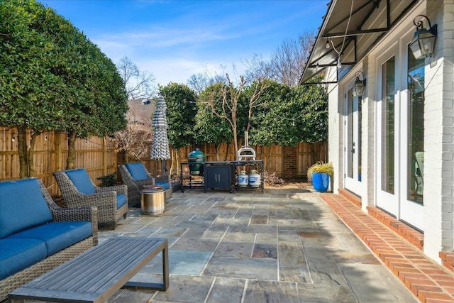 view of patio / terrace featuring grilling area and fence