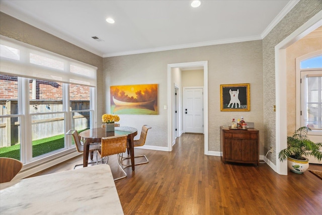 dining area featuring crown molding, dark wood finished floors, and baseboards