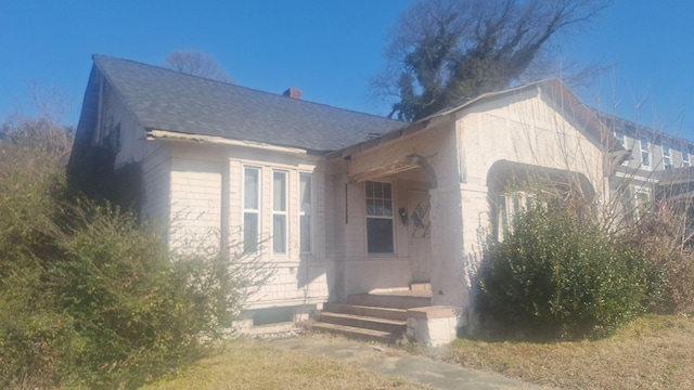 view of front of property featuring roof with shingles