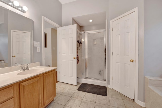 bathroom with tile patterned floors, vanity, and a shower stall