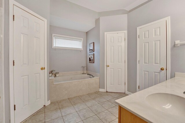 full bath with tile patterned flooring, double vanity, a bath, and a sink