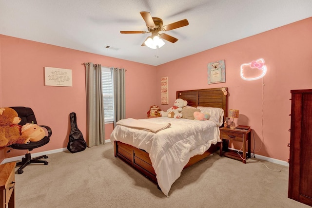 carpeted bedroom with visible vents, baseboards, and ceiling fan