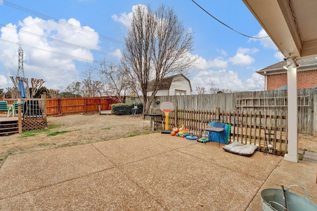 view of patio featuring a deck and a fenced backyard