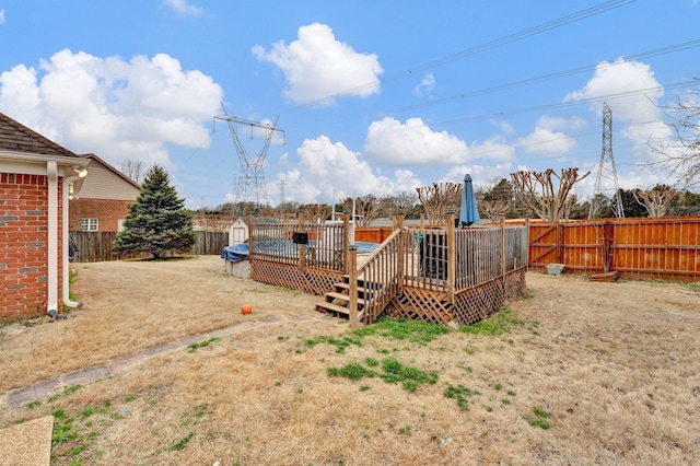 view of yard featuring a wooden deck and a fenced backyard