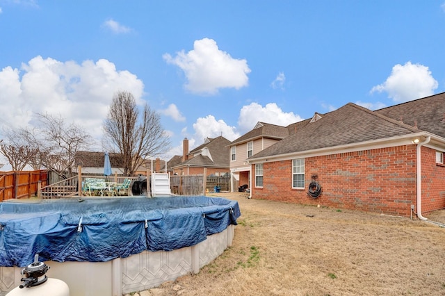 view of swimming pool featuring a fenced backyard, a fenced in pool, and a lawn